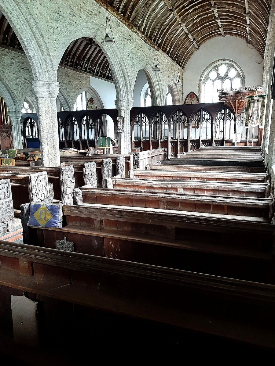 Granite arcades, timber roof, pews and the screen inside St Nonna’s.
