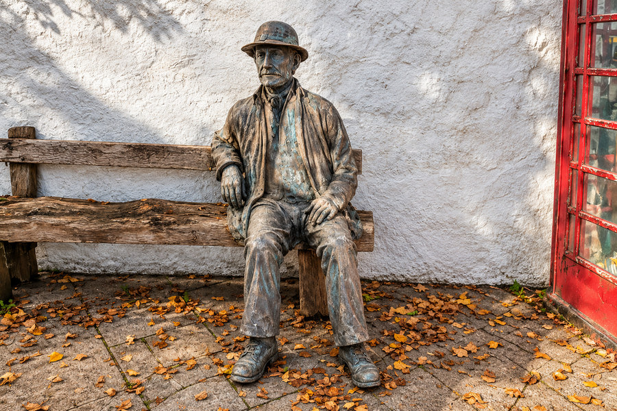 Seated figure of William the Miner on a bench in Gunnislake