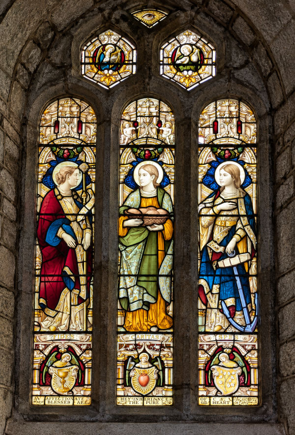The stained-glass window depicting Faith, Charity and Hope.