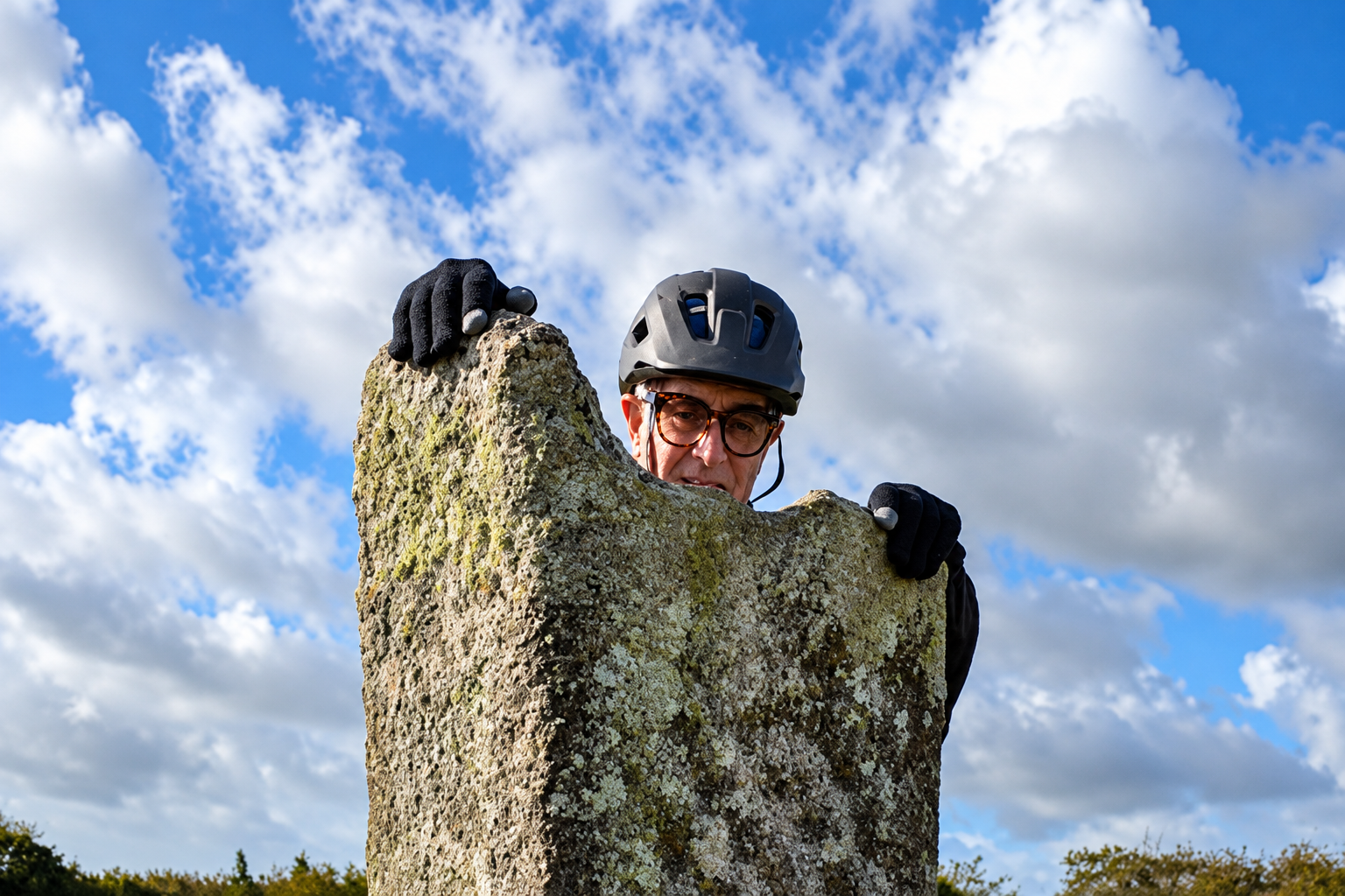 A cyclist examines a surviving feature of the local landscape.