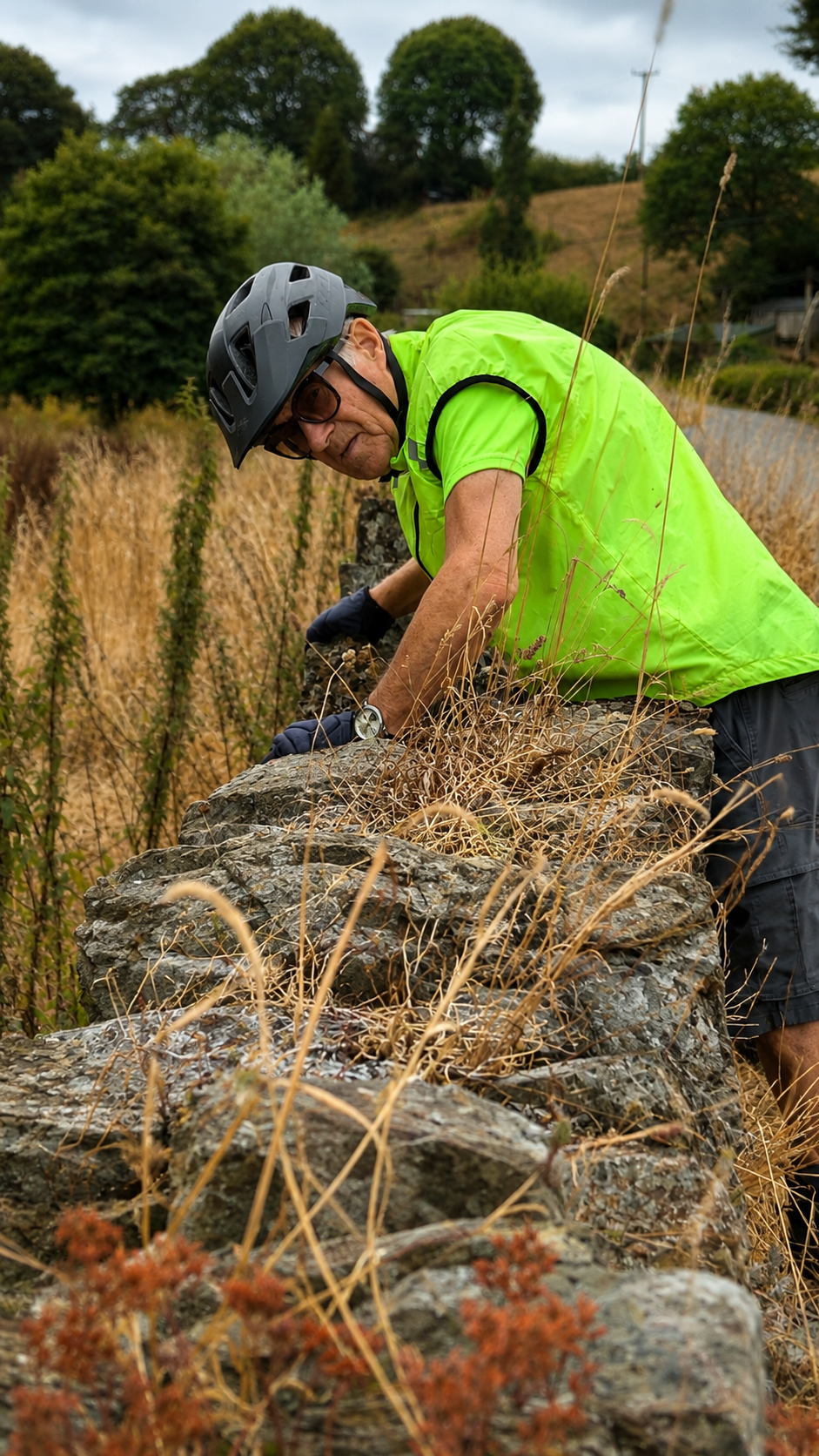 Cyclist by old stonework